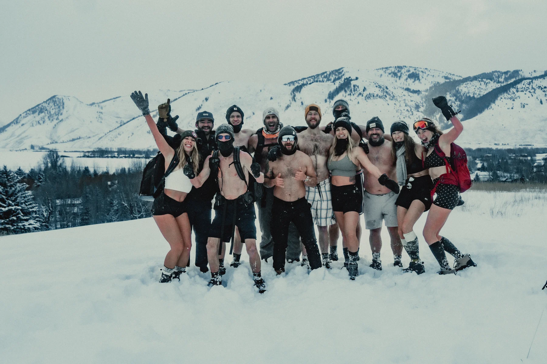 Joshua and a retreat group celebrating together in a snowy mountain landscape