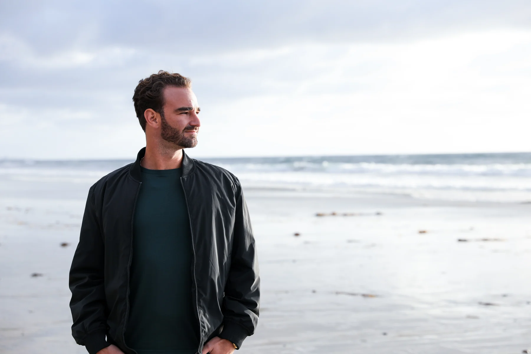 Joshua on the beach in San Diego, looking toward the ocean